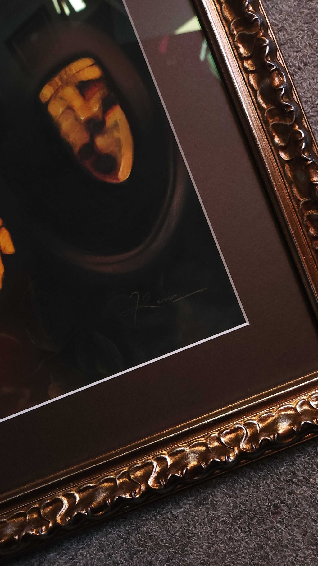Decorative gold frame with a dark interior, possibly for a photo or artwork.