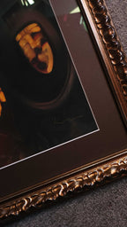 Decorative gold frame with a dark interior, possibly for a photo or artwork.