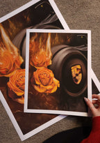 Two posters of a car with flames and roses held by a hand on a textured surface.