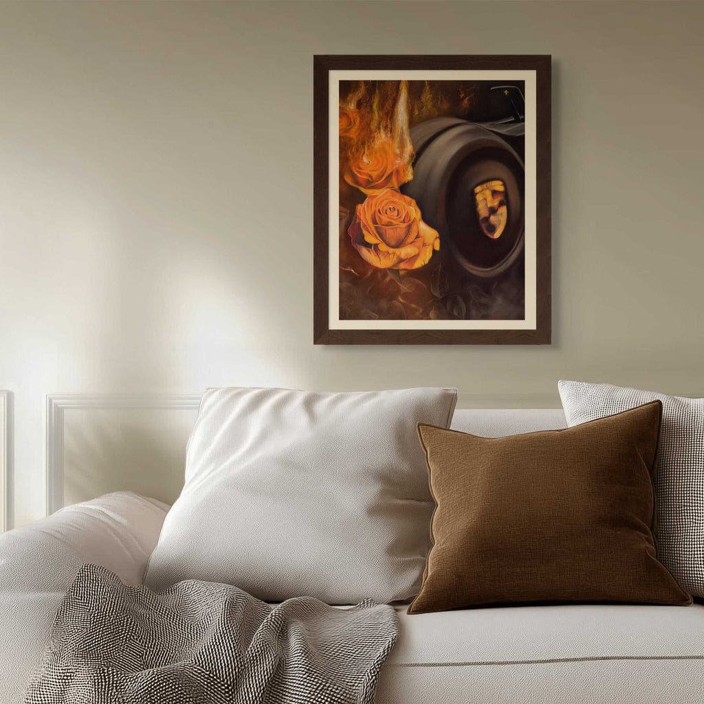 Framed artwork above a sofa with decorative pillows and a blanket.