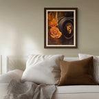 Framed artwork above a sofa with decorative pillows and a blanket.