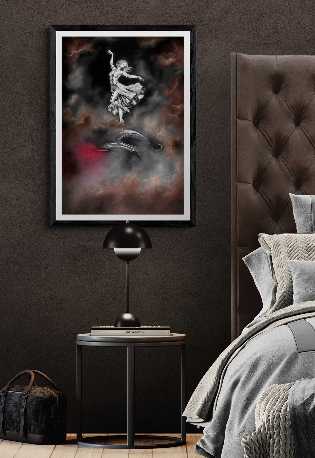 Modern bedroom with a dark wall, framed artwork, and a bed with gray bedding.