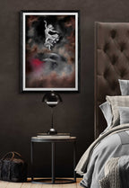 Modern bedroom with a dark wall, framed artwork, and a bed with gray bedding.