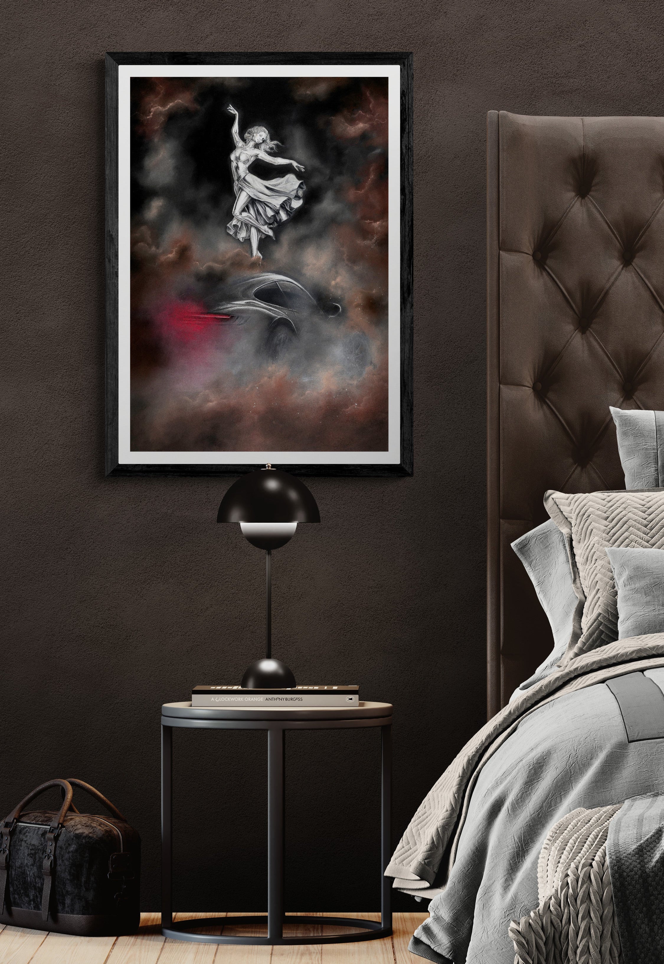 Modern bedroom with a dark wall, framed artwork, and a bed with gray bedding.